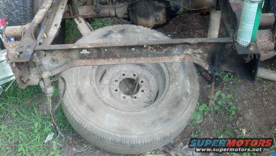 Close-up of a truck frame section with a spare tire mounted