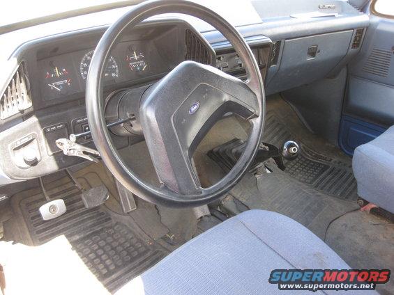 1988 Ford Bronco interior showing dashboard, steering wheel, and floor shifter