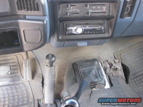 Interior view of a truck's dashboard and dual gear shifters