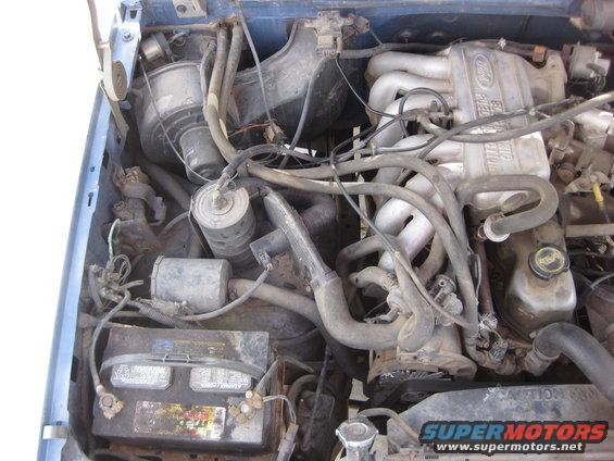 Engine bay with Ford fuel injection manifold and battery