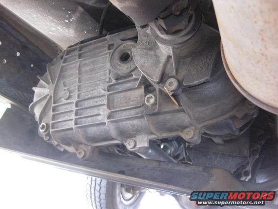 Underside view of a vehicle's transfer case with visible part numbers