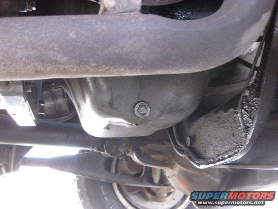 Underside view of a vehicle's oil pan and exhaust pipe