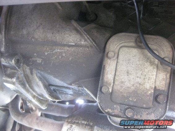 Underside view of a transmission housing and exhaust pipe