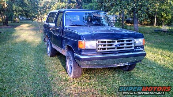 1988 Ford Bronco parked on grass, front 3/4 view