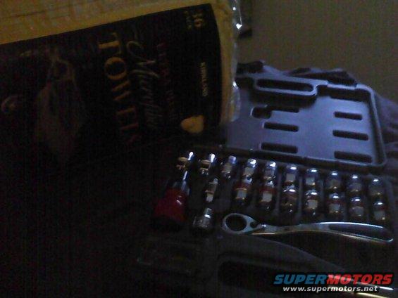 Tool kit with sockets and ratchet next to paper towels