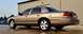 2005 Ford Crown Victoria - This gold 2005 Ford Crown Victoria is shown from the rear three-quarter angle.