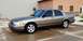 2005 Ford Crown Victoria - A 2005 Ford Crown Victoria sedan is parked outside a building.