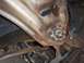 1971 Chevrolet Camaro - Detail of a heavily rusted vehicle frame and suspension components, with visible hoses and a mounting bracket.