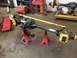1988 Ford Bronco - Front axle assembly with yellow brake calipers and a yellow steering stabilizer is shown on jack stands.