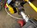 1988 Ford Bronco - This image shows a close-up view of a vehicle's suspension system, highlighting the brake caliper and associated plumbing.