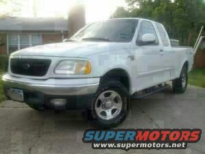 White 2003 Ford F-150 pickup truck parked on a driveway