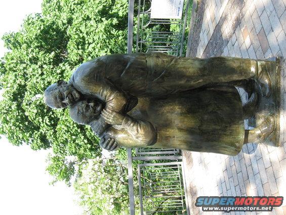 Bronze sculpture of two people embracing outdoors