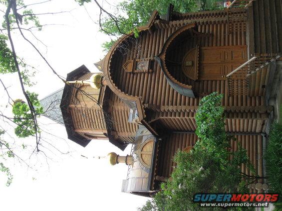Wooden building with multiple onion domes and intricate log construction