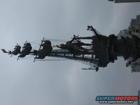 monumental ship sculpture against a cloudy sky