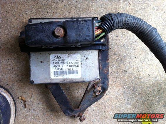 ABS controller with part number F47A-2C219-FA and wiring harness