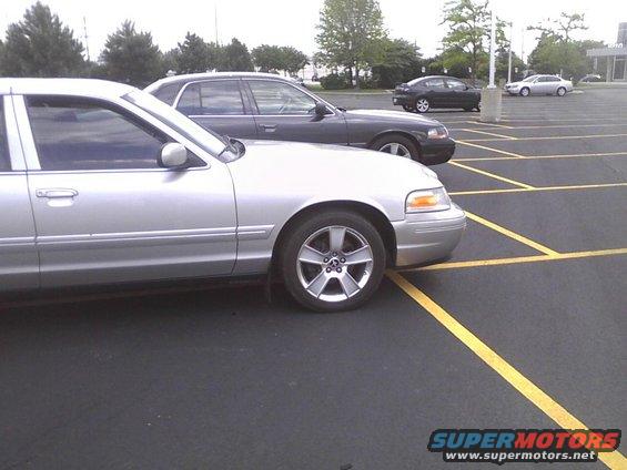 Silver sedan side view, parked in a lot