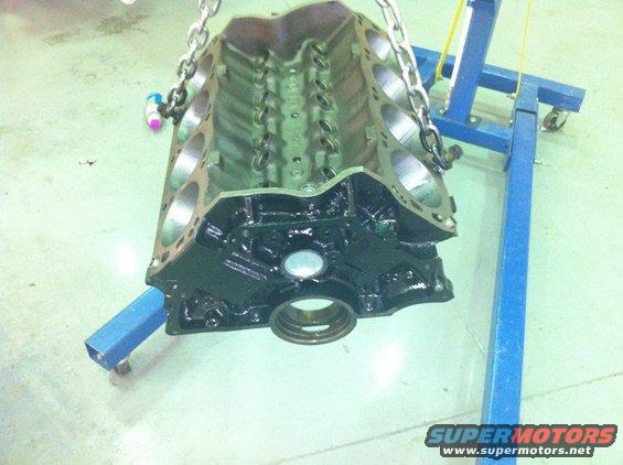 engine block being lifted by chains, supported by a blue engine stand
