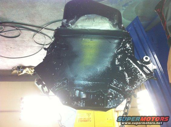 Black painted engine block suspended by chains