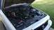 2008 Mercury Grand Marquis - The engine bay of a 2008 Mercury Grand Marquis is visible with the hood raised.