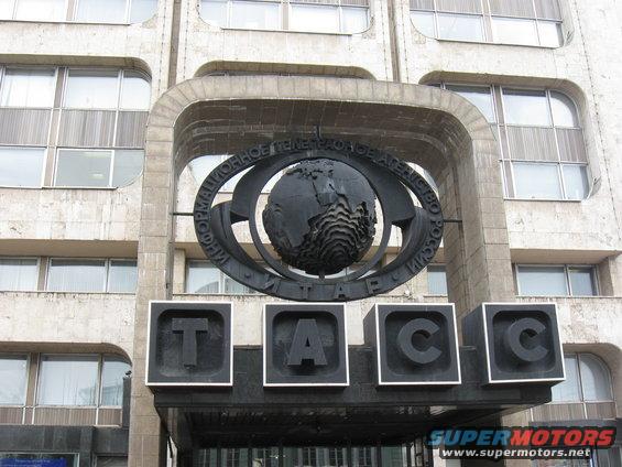Building facade with TASS logo and globe emblem