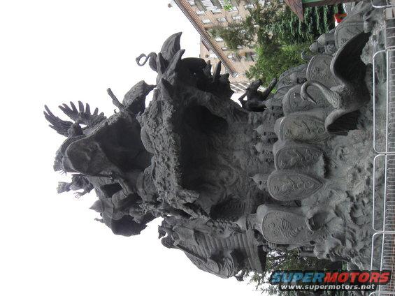 Ornate bronze sculpture with mythological figures and shields