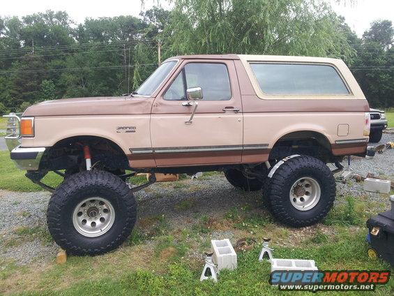 1988 Ford Bronco lifted with large tires, side view