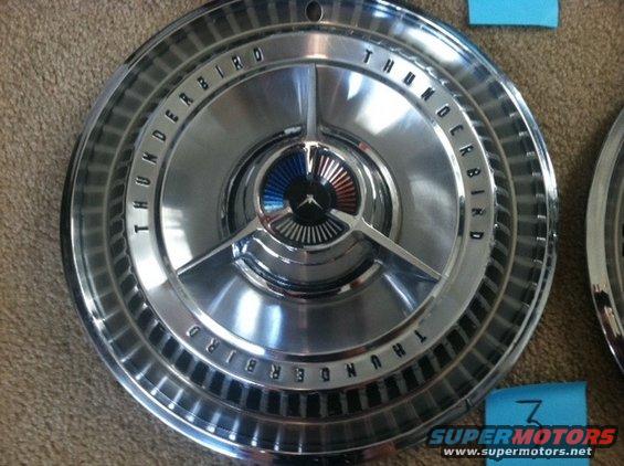 Close-up of a chrome hubcap with 'THUNDERBIRD' text around the edge