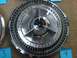 1965 Ford Thunderbird - A single chrome hubcap, identified as 'THUNDERBIRD', is displayed against a carpeted surface.