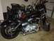1995 Ford Bronco - A black motorcycle is parked in a garage with various items in the background.