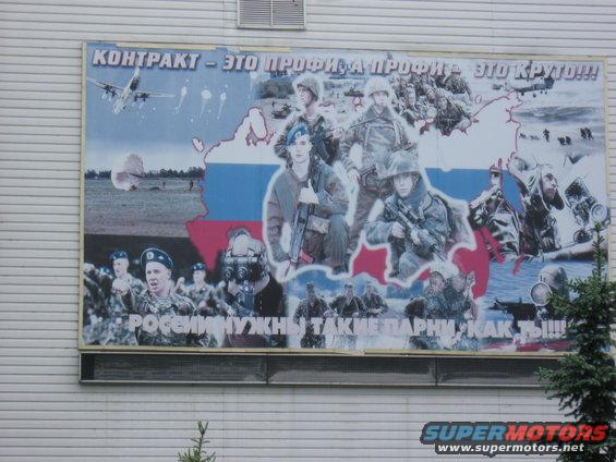 Mural of Russian soldiers with text about contract service