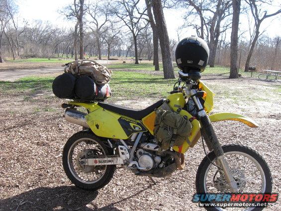 2006 Suzuki DR-Z400S dual-sport motorcycle loaded with camping gear and a helmet
