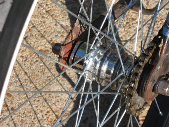 Close-up of a bicycle's chrome hub and chain