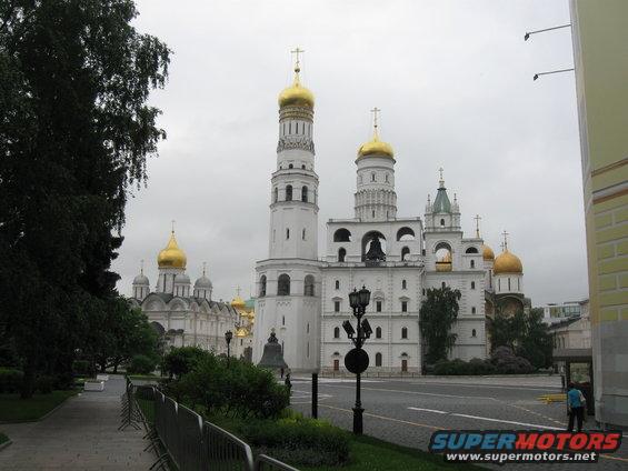 Kremlin cathedrals with golden domes under a cloudy sky