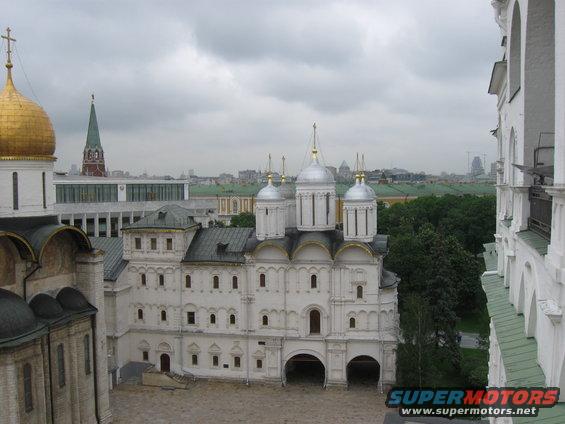 Kremlin cathedrals with golden and silver domes under a cloudy sky