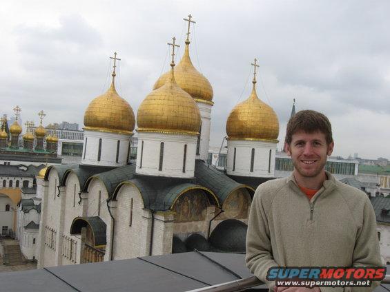 Guy in front of a church with many golden domes