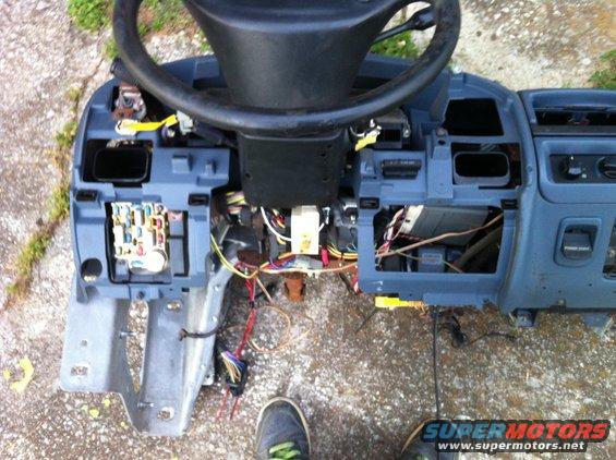 Disassembled dashboard and steering column with wiring exposed