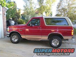 1995 Ford Bronco, red with tan trim, parked in driveway