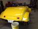 1975 Ford Ranchero - Yellow hot rod roadster in a garage, rear view. Texas license plate TSX-240 is visible.