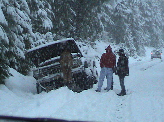 2003-christmas-treein-013.jpg Jim working on his broken truck, my Explorer is stuck behind him, he figured if he could move his then I shouldn't move mine either (just kidding Jim)
