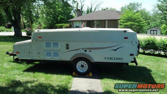 Side view of white Viking pop-up camper trailer