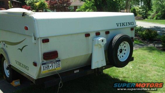 Rear view of a white Viking pop-up camper trailer with license plate XHK-9708