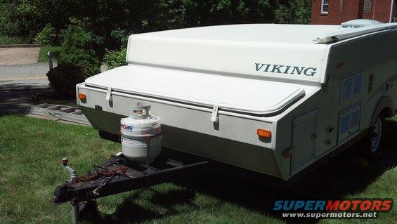 Pop-up camper trailer with 'VIKING' branding on top, propane tank on hitch