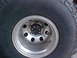 1992 Ford Bronco - A close-up view of a vehicle's tire and wheel assembly, showing the tread pattern and rim details.