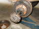 1992 Ford Bronco - Close-up of a vehicle's wheel hub and brake assembly, with the brake drum detached.