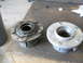 1992 Ford Bronco - Two wheel hubs are shown on a workbench, one showing signs of wear and welding, the other appearing new.