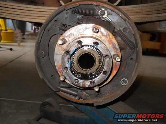 Close-up of a vehicle's wheel hub and brake drum assembly, showing the bearing and brake shoes