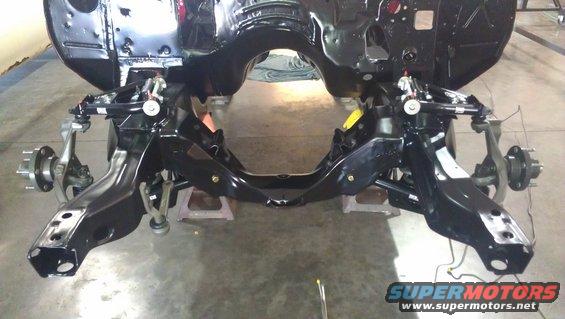 black painted car frame with front suspension and brake assemblies