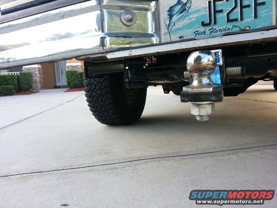 1994 Ford Bronco rear tire and chrome trailer hitch with a "Fish Florida" license plate