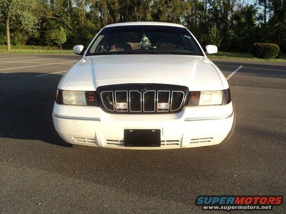 White 2000 Mercury Grand Marquis front grille with chrome accents