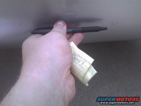 Hand holding pen and O'Reilly Auto Parts receipt